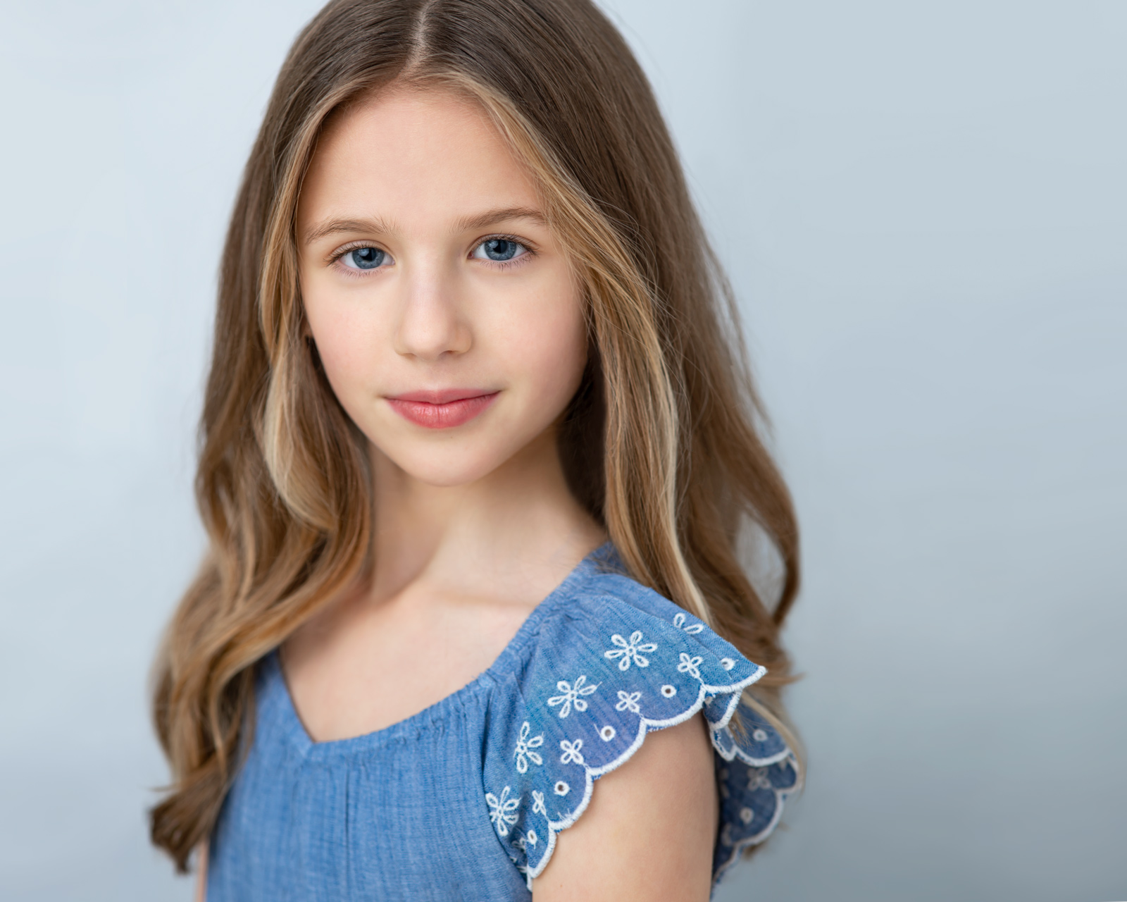 girl wearing a blue dress in child portrait