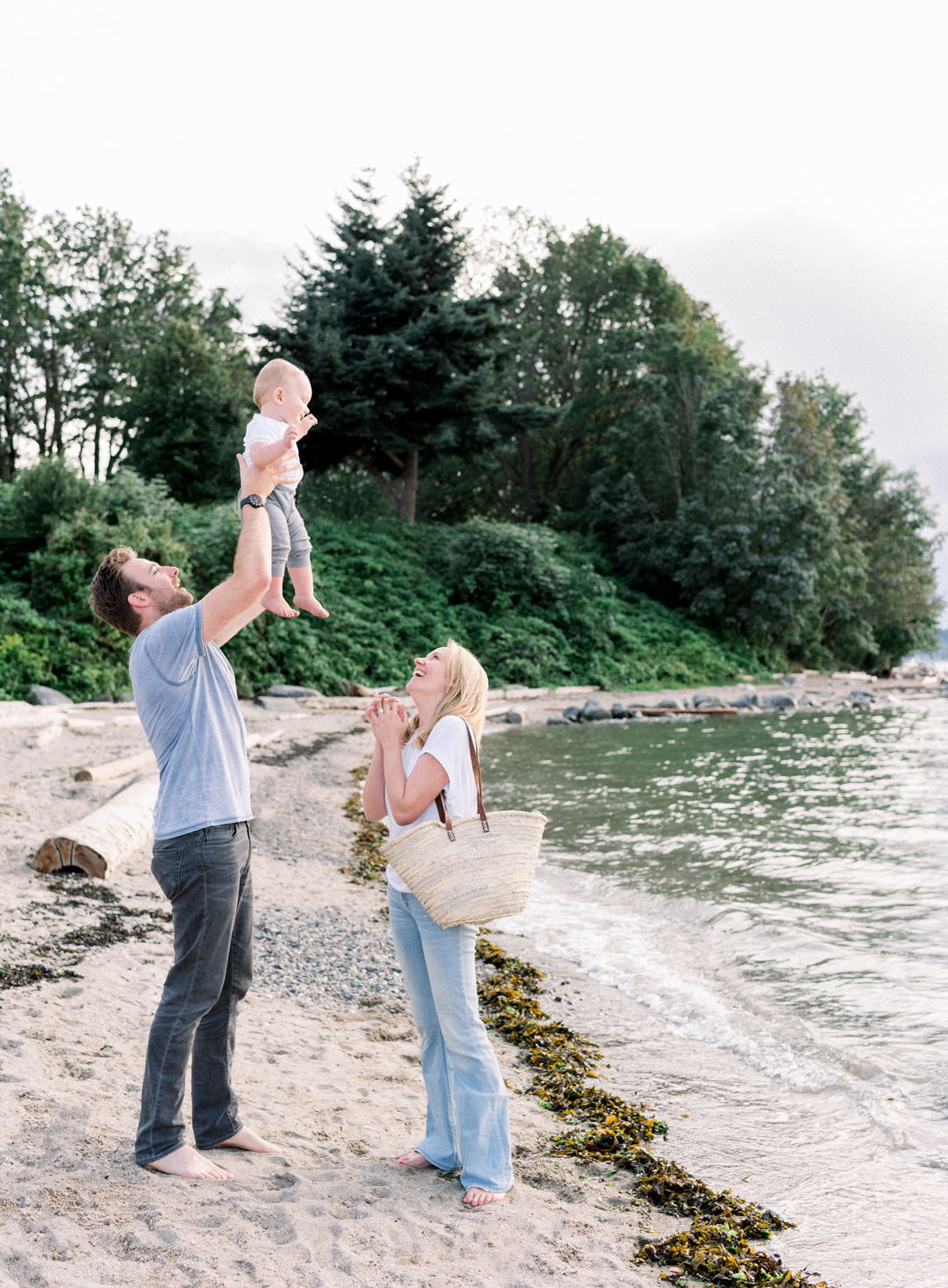 Vancouver parents playing with baby on the beach