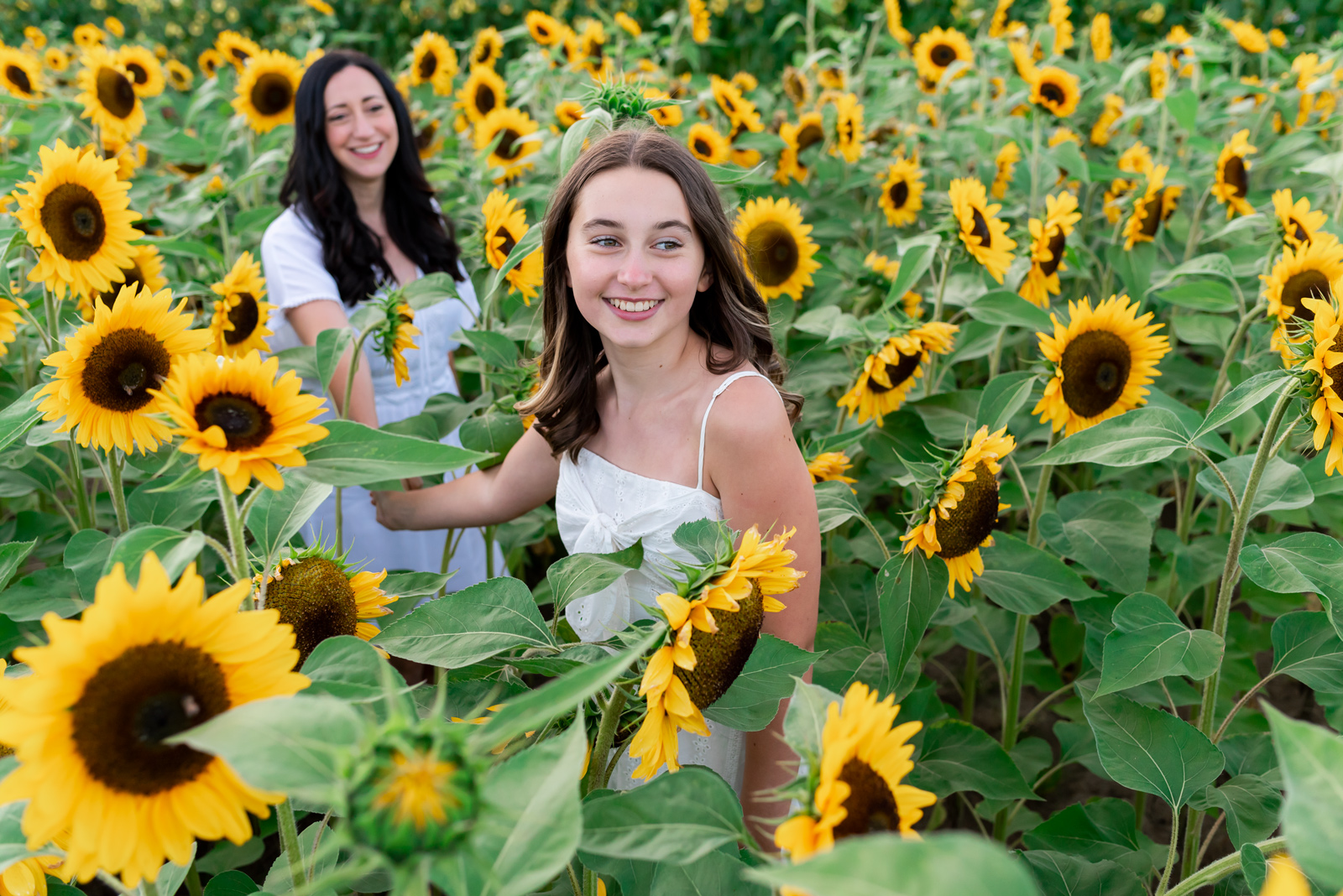 Candid fun family photos in field of flowers
