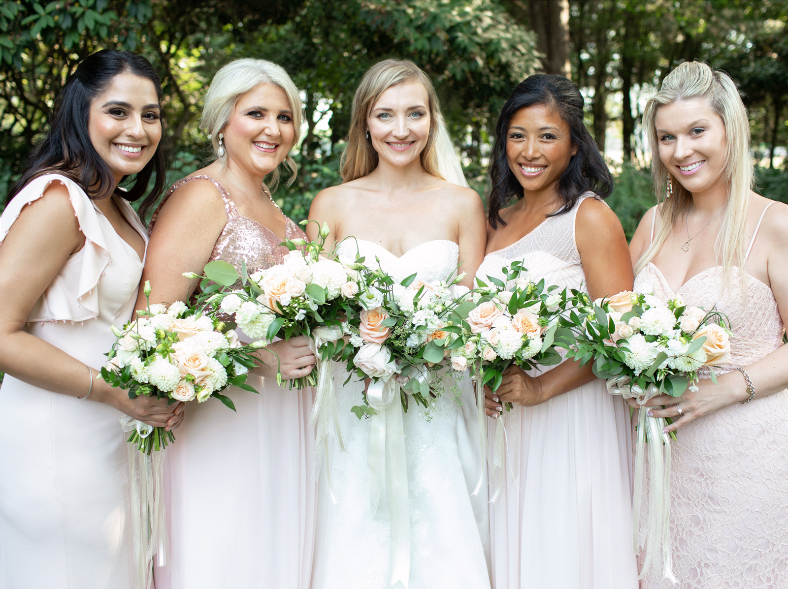 Bride and bridesmaids holding bouquets, Sechelt Botanical Garden.